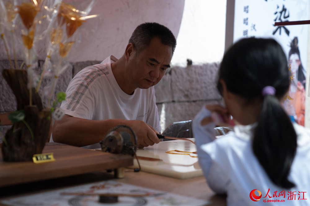 5月26日，在浙江省嘉興市月河街的一家店鋪內(nèi)，師傅正在為客人制作糖人。人民網(wǎng) 陳陸洵攝